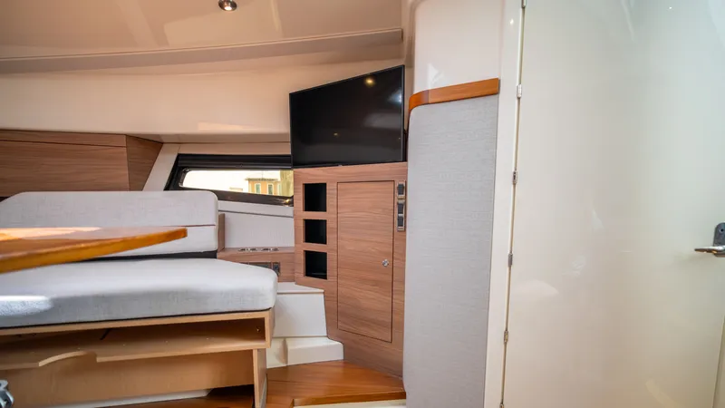 Slide: The Image of Interior of 2026 Boston Whaler 365 Conquest with TV and seating area. - 22