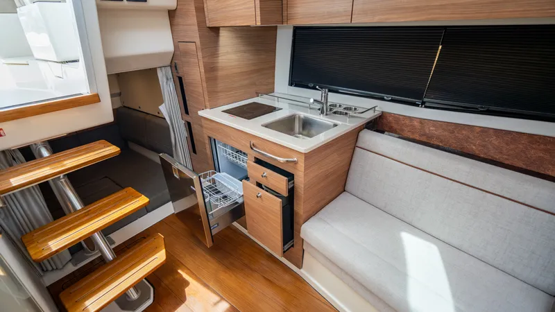 Slide: The Image of Interior of 2026 Boston Whaler 365 Conquest with kitchen and seating area. - 24