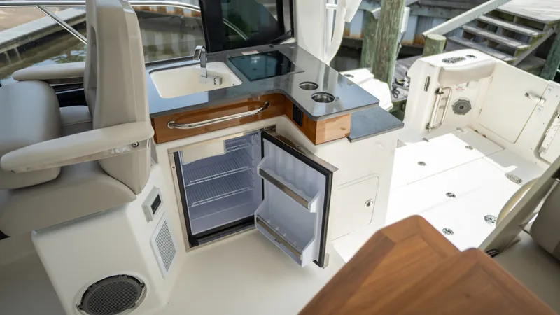 Slide: The Image of Interior of 2026 Boston Whaler 365 Conquest with fridge and sink. - 32