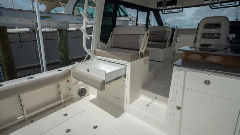 Slide: The Image of Interior of 2026 Boston Whaler 365 Conquest with seating and storage. - 38