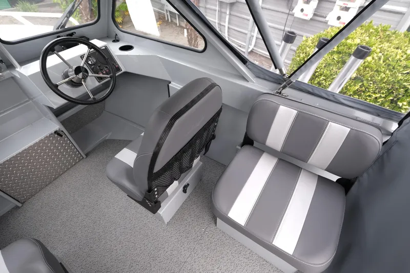 Slide: The Image of 2025 Hewescraft 200 Sportsman interior with gray seating and steering console. - 11