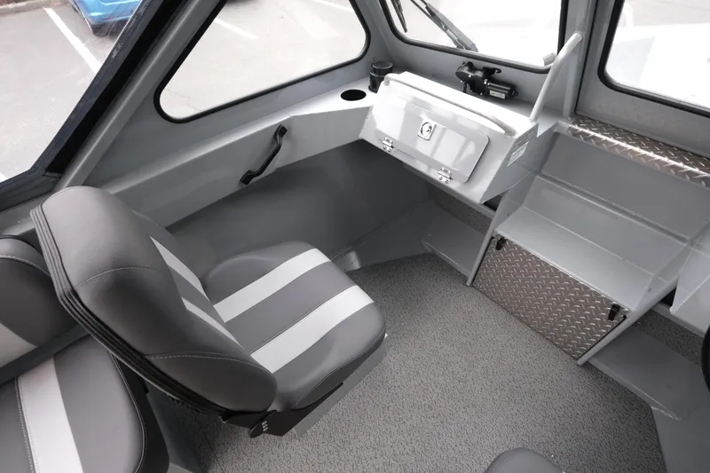 Slide: The Image of Interior of 2025 Hewescraft 200 Sportsman boat, featuring seating and storage compartments. - 13