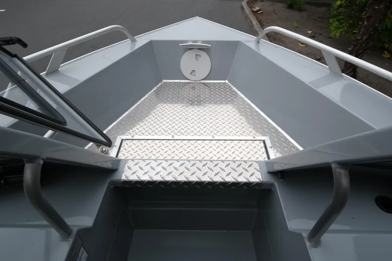 Slide: The Image of 2025 Hewescraft 200 Sportsman boat interior with diamond plate flooring. - 14