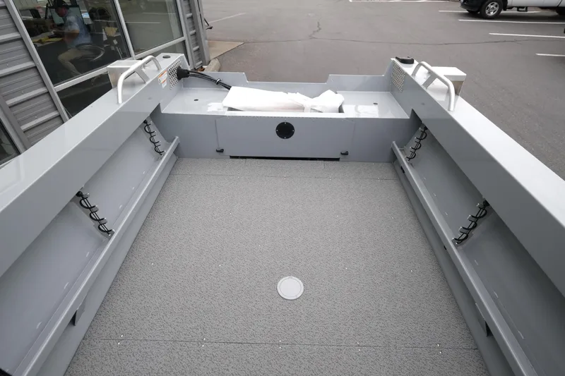 Slide: The Image of 2025 Hewescraft 200 Sportsman boat interior with spacious deck and storage compartments. - 8