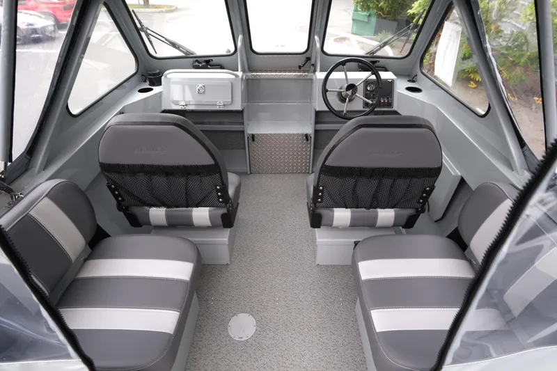 Slide: The Image of Interior of 2025 Hewescraft 200 Sportsman boat with seating and steering console. - 9