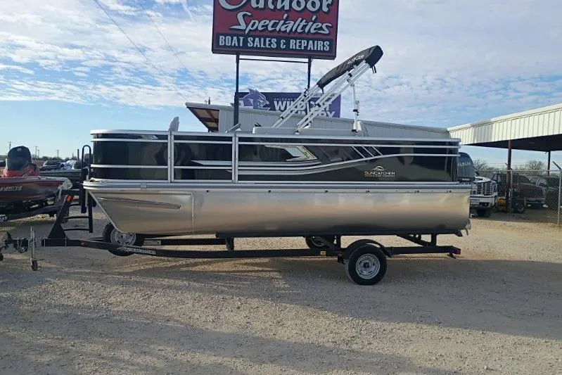 The Image of 2026 SunCatcher Select 18F pontoon boat on trailer at dealership. - 0