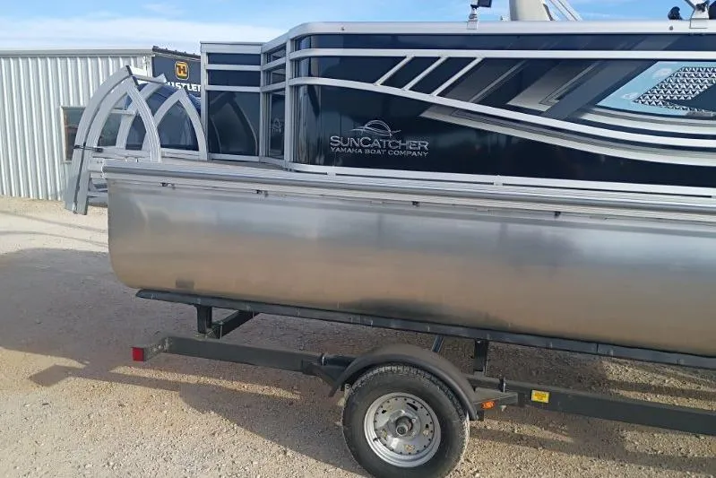 Slide: The Image of 2026 SunCatcher Select 18F pontoon boat on trailer, parked outdoors. - 2