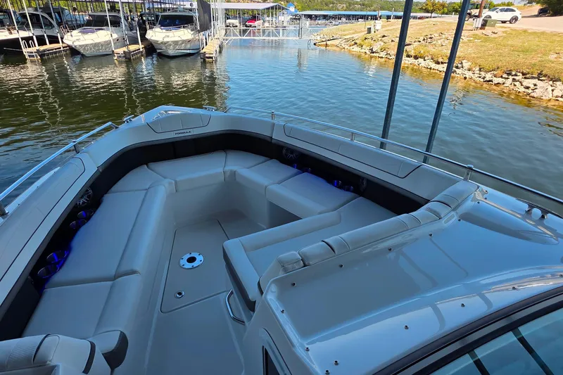 Slide: The Image of 2026 Formula 350 Crossover Bowrider I/O with spacious seating at a marina. - 17