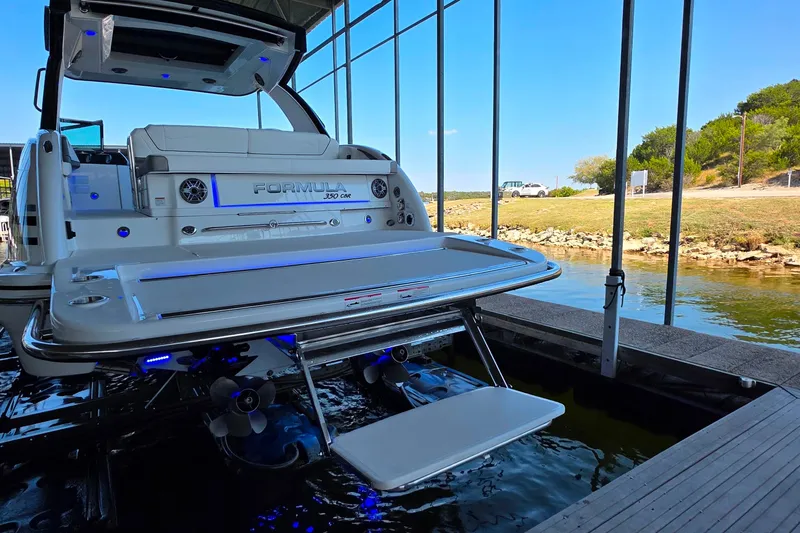 Slide: The Image of 2026 Formula 350 Crossover Bowrider I/O docked, showcasing sleek design and modern features. - 4