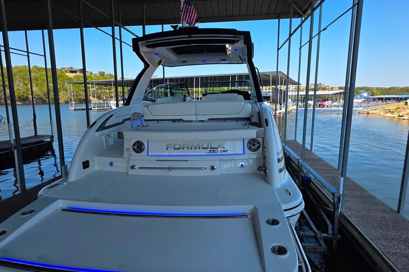 Slide: The Image of 2026 Formula 350 Crossover Bowrider I/O docked at a marina with scenic lake view. - 5