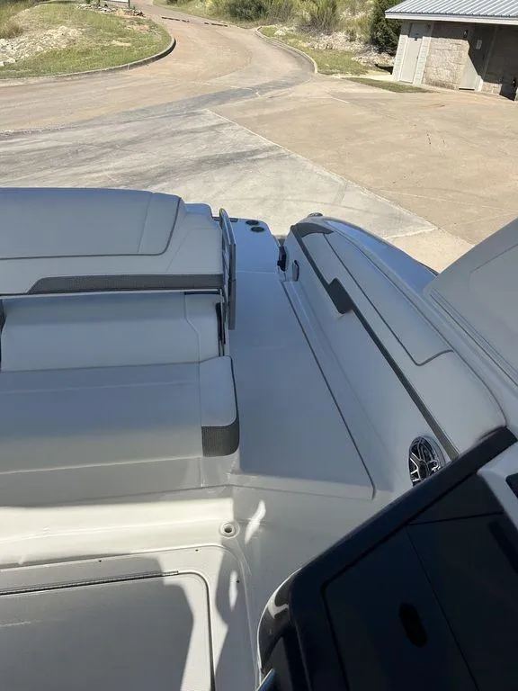 Slide: The Image of 2025 Formula 310 Bowrider boat, rear deck view, parked on a concrete surface. - 16