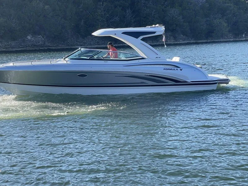 Slide: The Image of 2025 Formula 310 Bowrider cruising on a serene lake. - 4