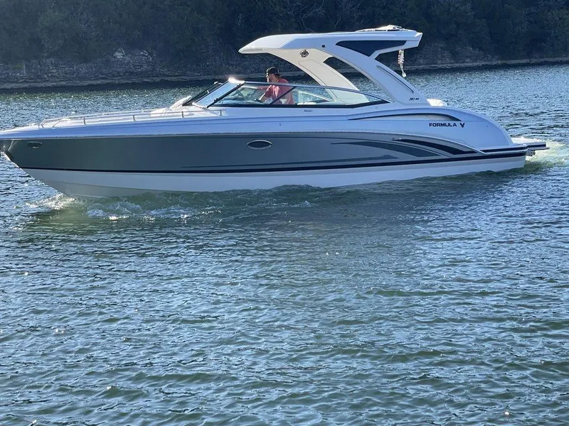 Slide: The Image of 2025 Formula 310 Bowrider cruising on a serene lake. - 6