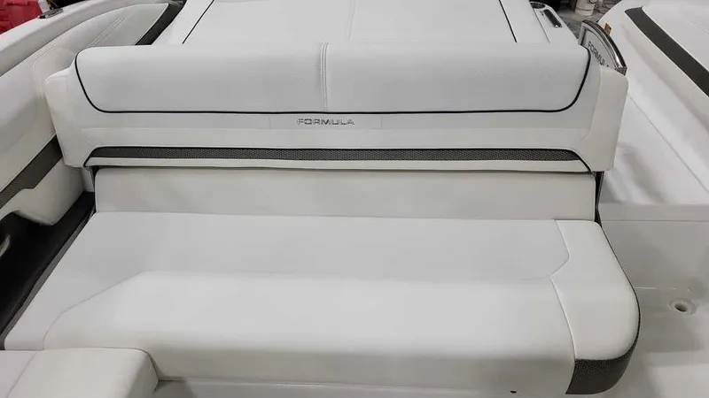 Slide: The Image of 2025 Formula 240 Bowrider boat interior with white cushioned seating. - 13