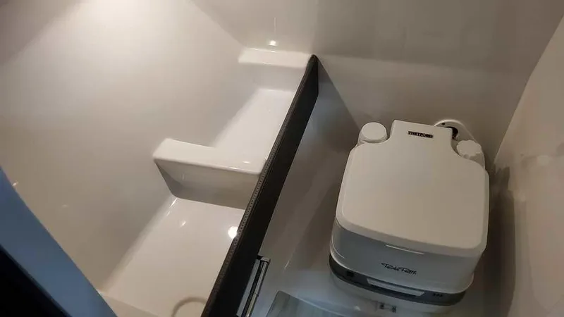 Slide: The Image of 2025 Formula 240 Bowrider interior with compact portable toilet. - 19