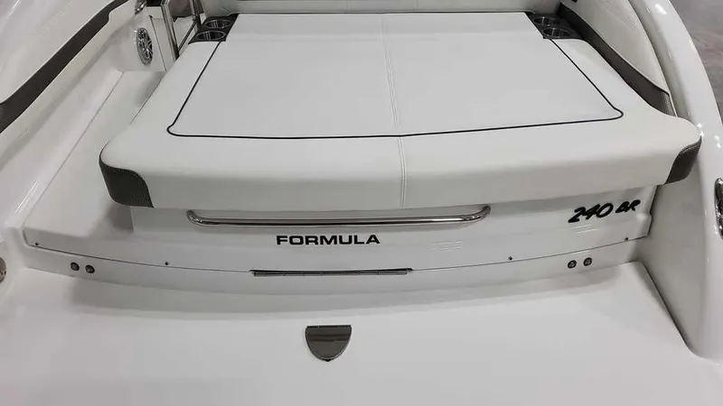 Slide: The Image of 2025 Formula 240 Bowrider boat, rear view with sleek white design and branding. - 28