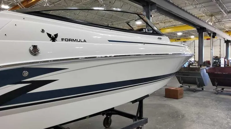 Slide: The Image of 2025 Formula 240 Bowrider boat in a warehouse setting. - 3