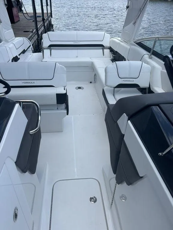 Slide: The Image of 2025 Formula 290 Bowrider interior with sleek white seating and open deck design. - 13