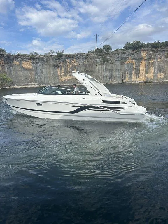 Slide: The Image of 2025 Formula 290 Bowrider cruising on a scenic lake with rocky cliffs. - 5