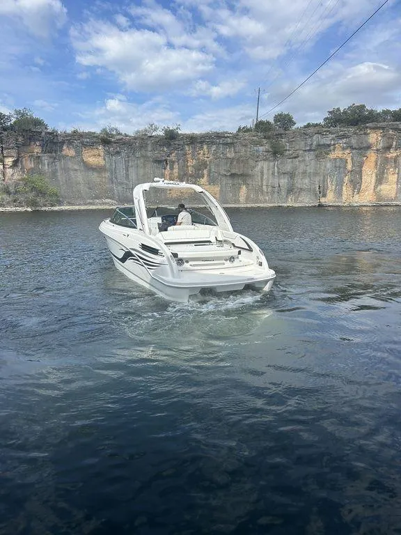 Slide: The Image of 2025 Formula 290 Bowrider cruising on a scenic lake with rocky cliffs. - 6