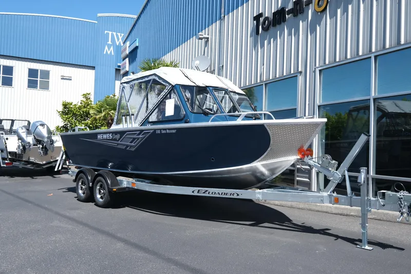 The Image of 2025 Hewescraft 210 Sea Runner ET boat on trailer outside dealership. - 1