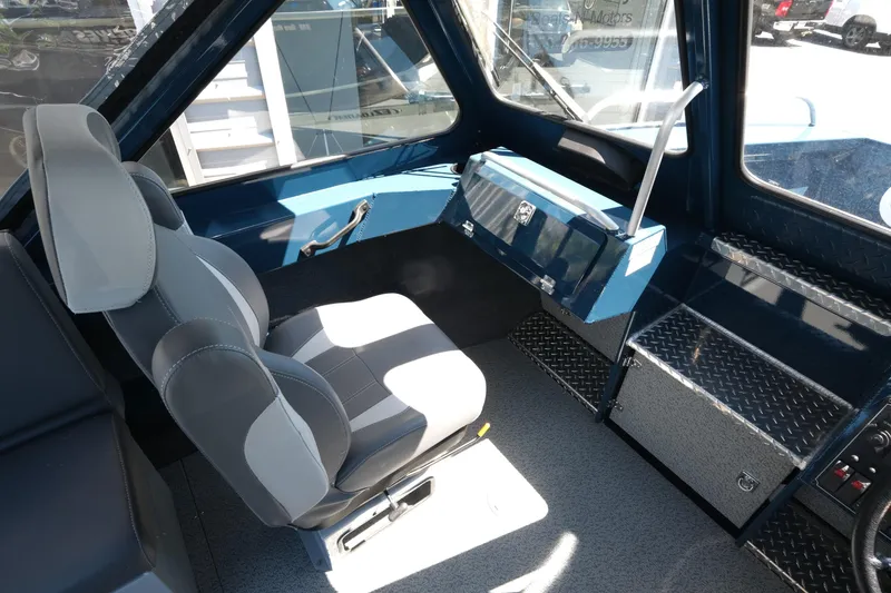 Slide: The Image of Interior of 2025 Hewescraft 210 Sea Runner ET boat, featuring modern seating and controls. - 14