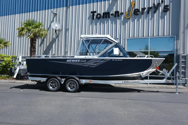 Slide: The Image of 2025 Hewescraft 210 Sea Runner ET boat on trailer outside dealership. - 2