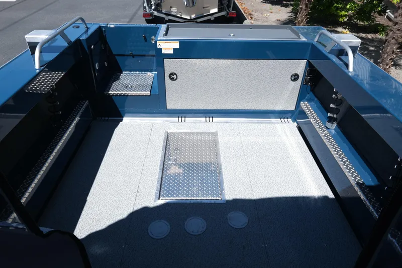 Slide: The Image of 2025 Hewescraft 210 Sea Runner ET boat interior with spacious deck and storage compartments. - 7