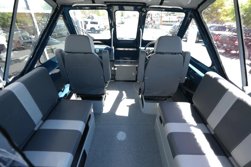 Slide: The Image of Interior of 2025 Hewescraft 210 Sea Runner ET boat, featuring spacious seating and modern design. - 8