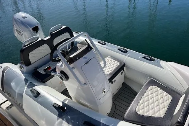 Slide: The Image of 1997 Sea Ray 450 Sundancer boat interior with steering console and cushioned seating. - 14