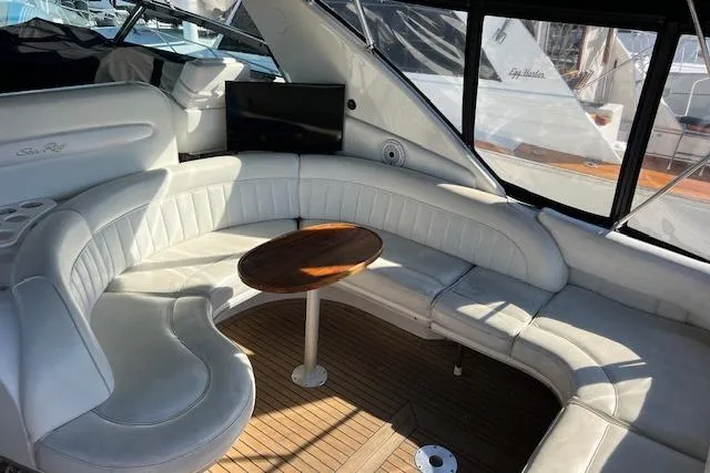 Slide: The Image of 1997 Sea Ray 450 Sundancer yacht interior with white leather seating and wooden table. - 17