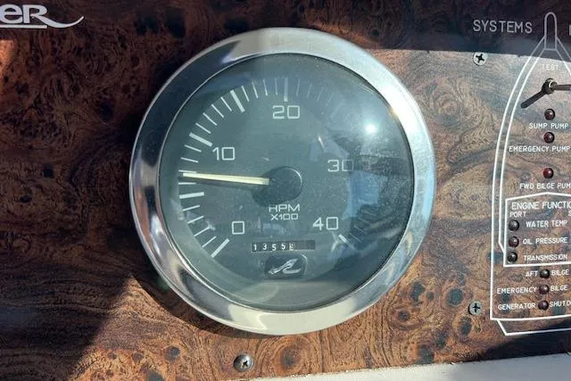 Slide: The Image of Tachometer of 1997 Sea Ray 450 Sundancer boat, showing RPM and system controls. - 21