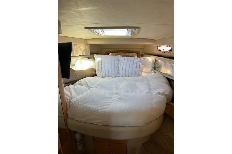 Slide: The Image of Cozy bedroom interior of 1997 Sea Ray 450 Sundancer yacht with plush bedding. - 29