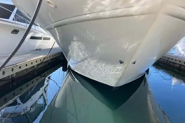 Slide: The Image of 1997 Sea Ray 450 Sundancer yacht docked in a marina under clear blue skies. - 3