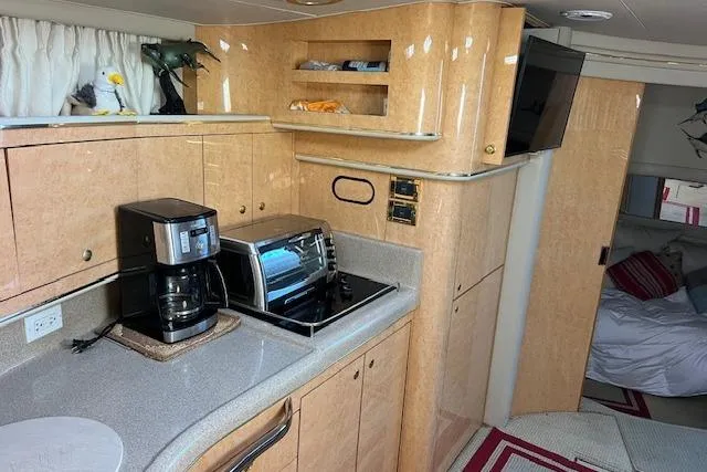 Slide: The Image of Interior of 1997 Sea Ray 450 Sundancer yacht with kitchen appliances and cozy cabin. - 35