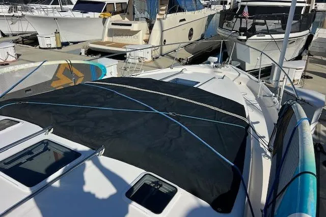 Slide: The Image of 1997 Sea Ray 450 Sundancer yacht docked, featuring a covered deck and nearby boats. - 43