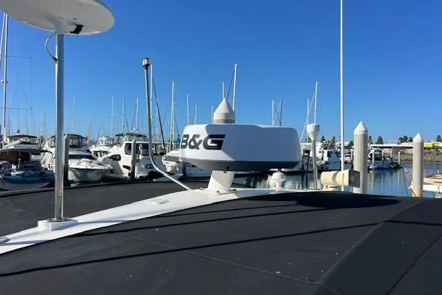 Slide: The Image of 1997 Sea Ray 450 Sundancer with radar at marina, surrounded by boats. - 47