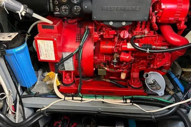 Slide: The Image of Engine room of a 1997 Sea Ray 450 Sundancer with a red Westerbeke generator. - 49