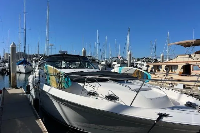 Slide: The Image of 1997 Sea Ray 450 Sundancer yacht docked at marina with clear blue sky. - 5