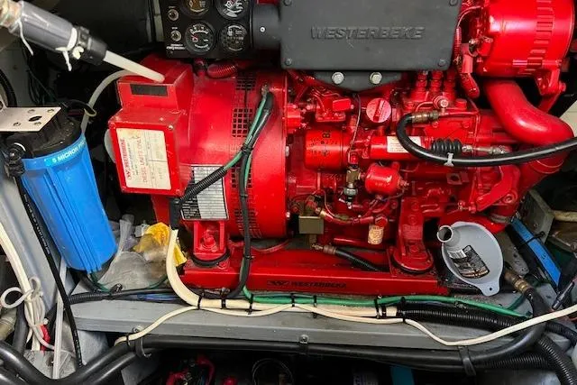 Slide: The Image of Engine room of 1997 Sea Ray 450 Sundancer with red Westerbeke generator. - 50