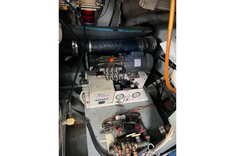 Slide: The Image of Engine room of 1997 Sea Ray 450 Sundancer with mechanical components and gauges. - 52