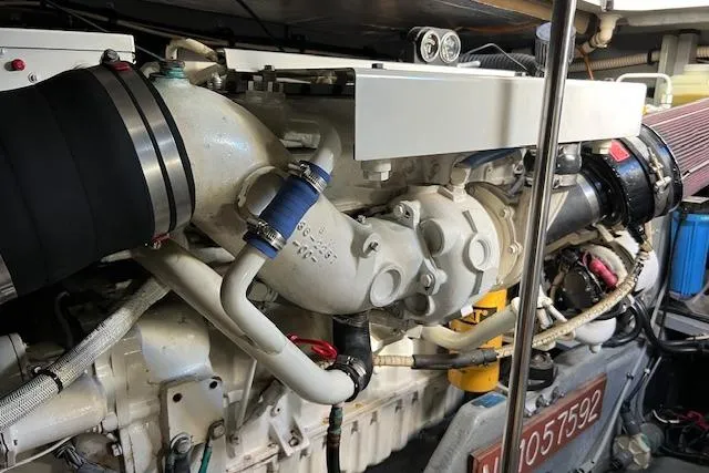 Slide: The Image of Engine of a 1997 Sea Ray 450 Sundancer boat, showcasing intricate mechanical components. - 54