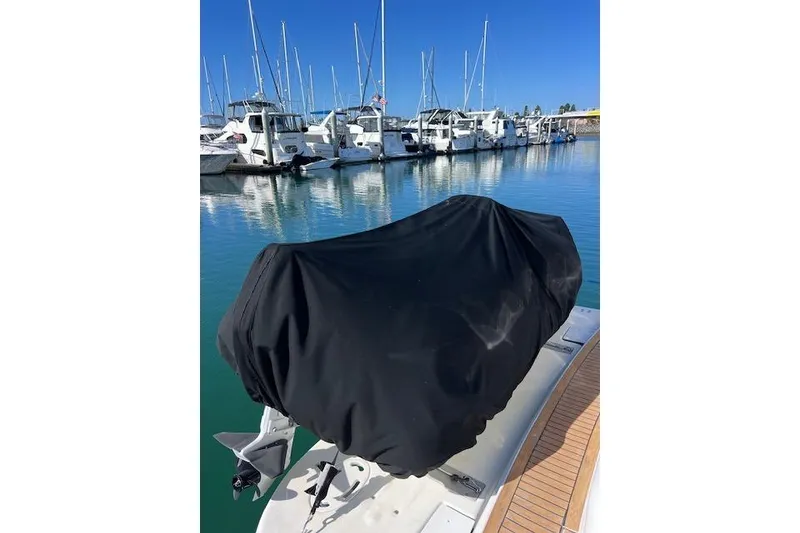 Slide: The Image of 1997 Sea Ray 450 Sundancer at marina, covered equipment on deck, clear blue sky. - 8