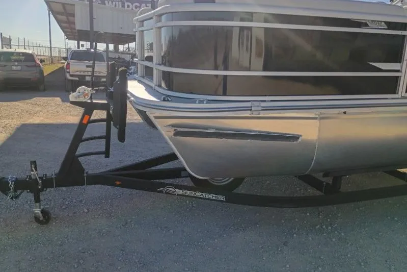 Slide: The Image of 2026 SunCatcher Select 20RC pontoon boat on trailer in outdoor setting. - 11