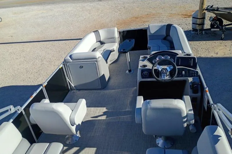 Slide: The Image of 2026 SunCatcher Select 20RC pontoon boat interior with modern seating and steering console. - 2