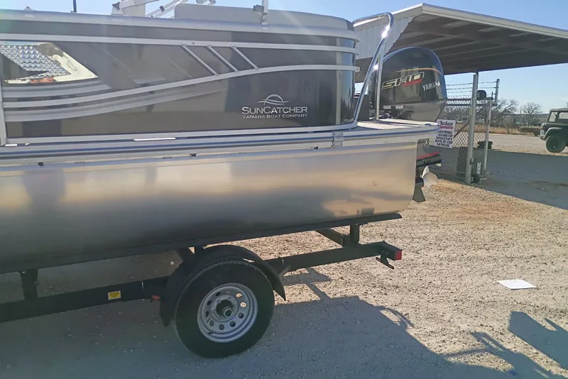 Slide: The Image of 2026 SunCatcher Select 20RC pontoon boat on trailer, parked outdoors. - 3