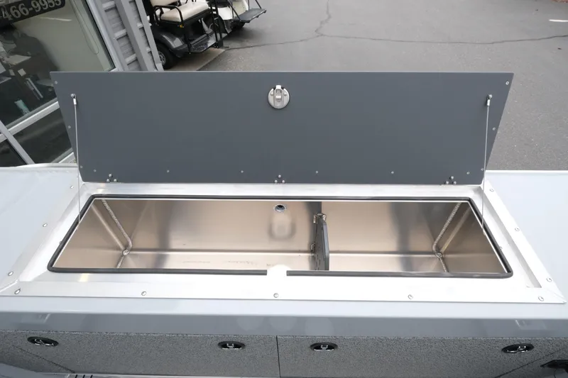 Slide: The Image of 2026 Hewescraft 180 ProV ET boat with open storage compartment. - 14