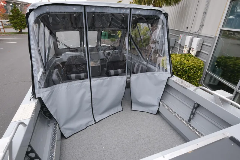 Slide: The Image of 2026 Hewescraft 180 ProV ET boat with enclosed cabin and gray cover. - 5