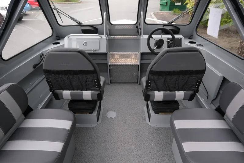 Slide: The Image of Interior of 2026 Hewescraft 180 ProV ET boat with gray seating and steering wheel. - 7