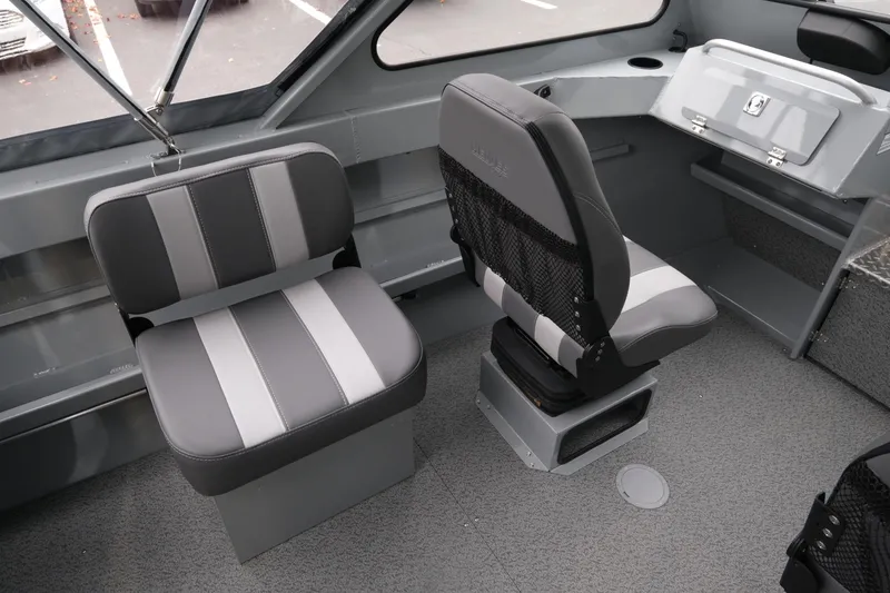 Slide: The Image of Interior of 2026 Hewescraft 180 ProV ET boat with gray seating and storage. - 8
